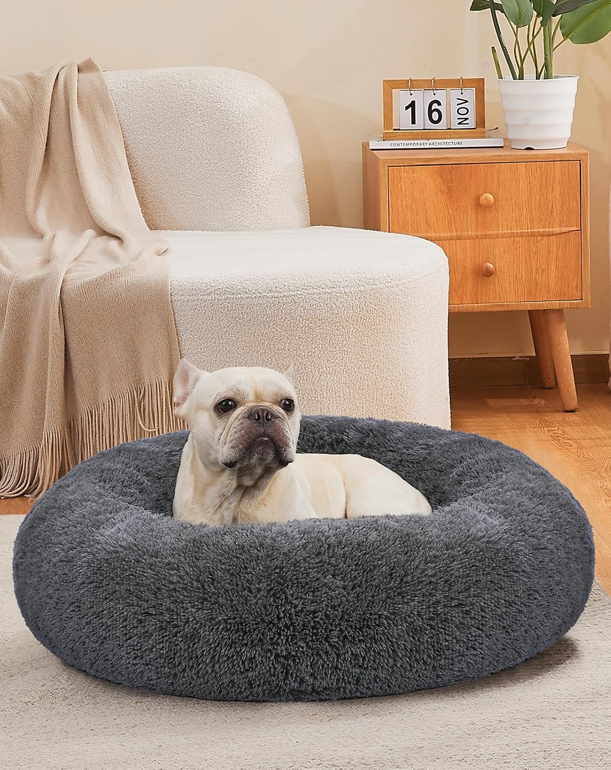 Dog resting in a calming donut pet bed